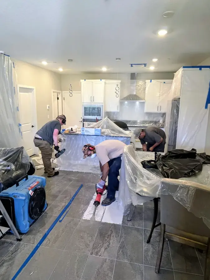 Water damage restoration technician setting drying equipment inside a Las Vegas home